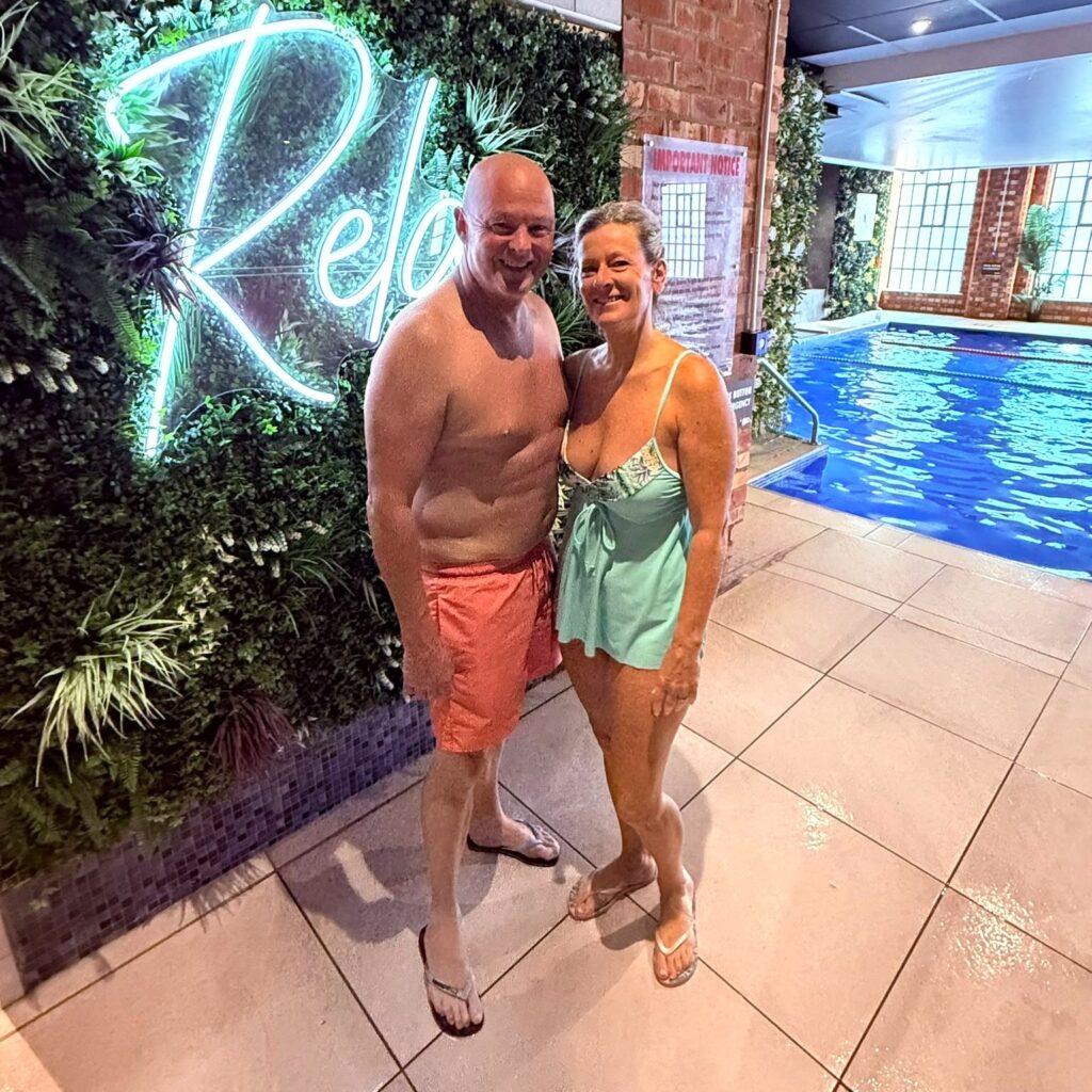 Couple relaxing by the pool at The Regent Health Club & Spa